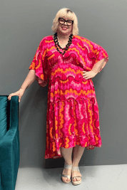 Floaty, tiered plus size dress for beach or casual outings, featuring a comfortable fit and versatile styling options.