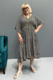 Floaty tiered dress perfect for plus size women, featuring shirring for comfort and a flattering shape, ideal for casual outings or dressing up.