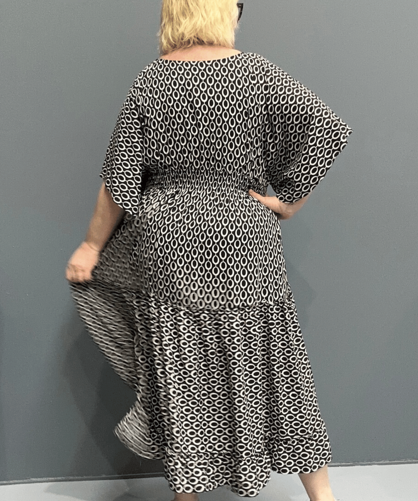 Floaty tiered dress perfect for plus size women, featuring shirring for comfort and a flattering shape, ideal for casual outings or dressing up.