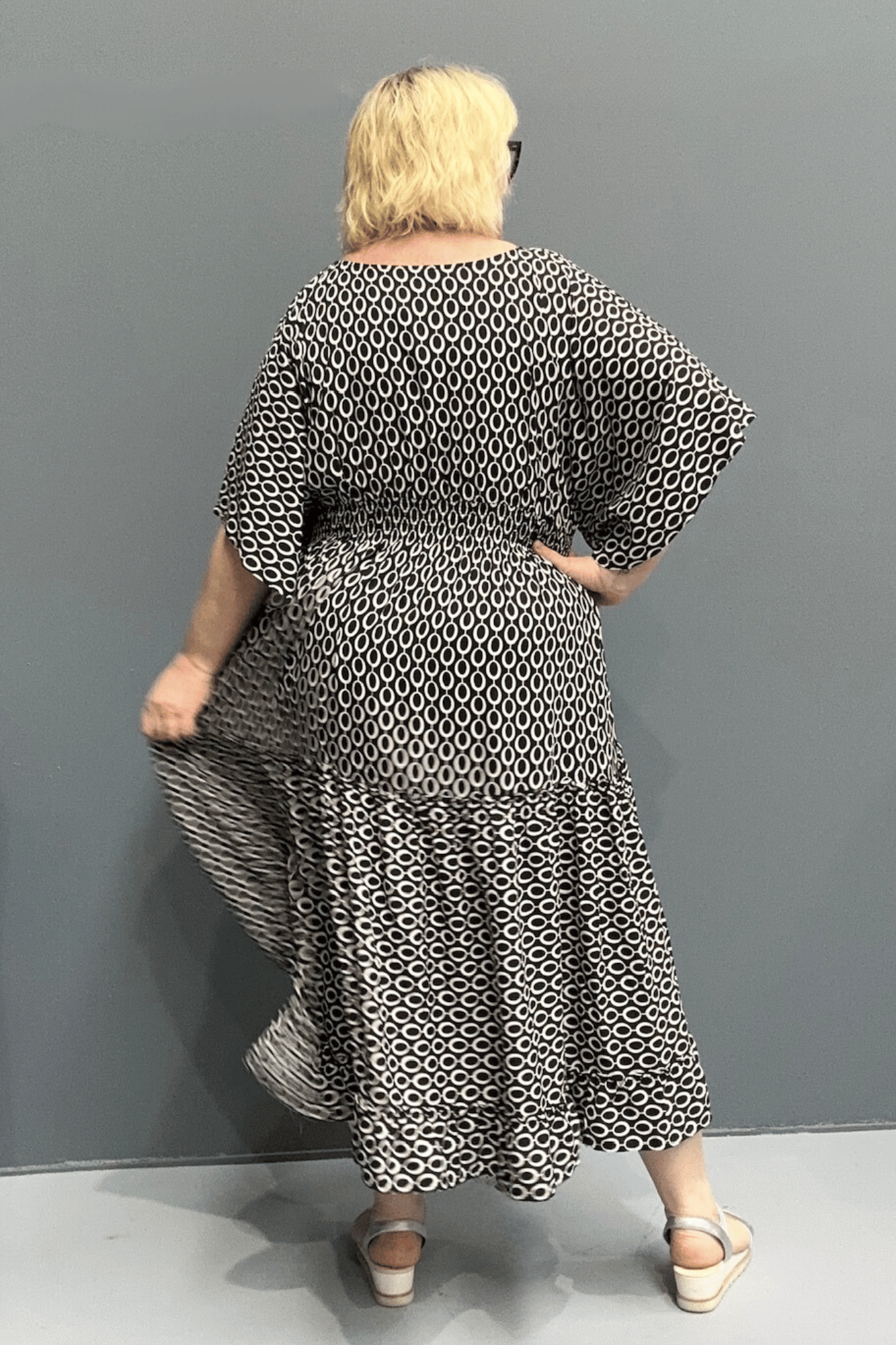 Floaty tiered dress perfect for plus size women, featuring shirring for comfort and a flattering shape, ideal for casual outings or dressing up.