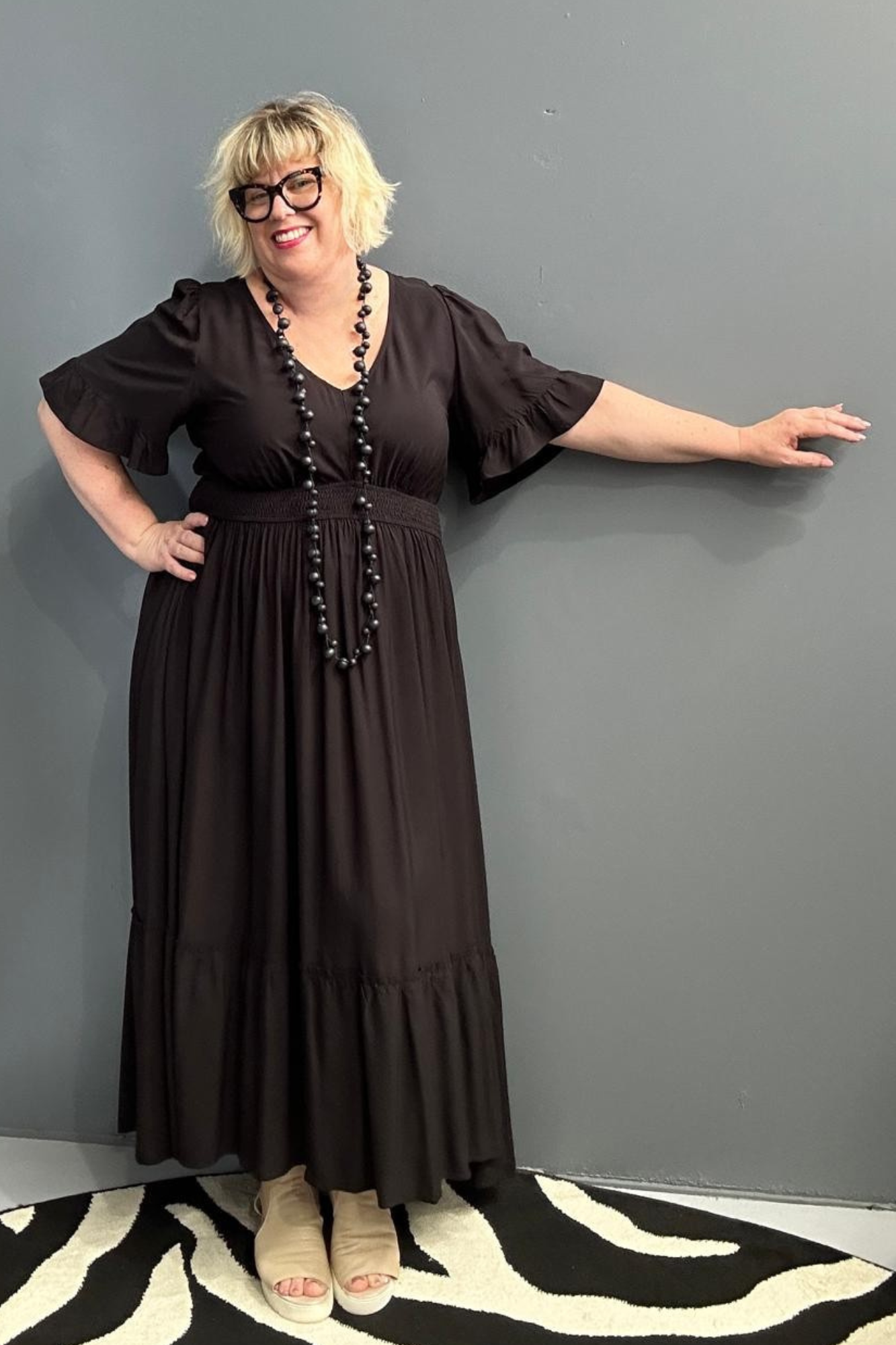 Plus-size black maxi dress with a soft, flowing silhouette.