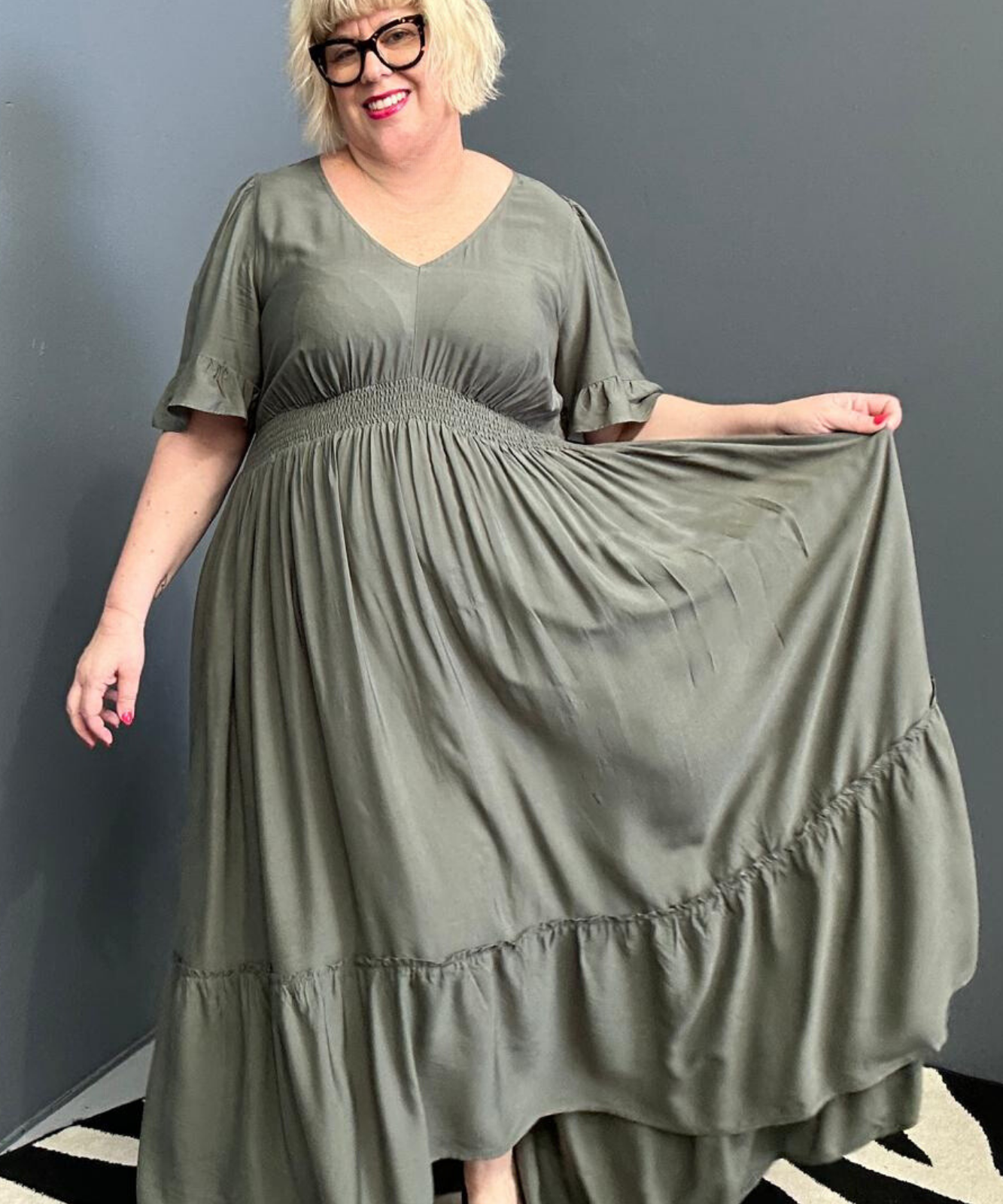 Plus-size olive maxi dress with a soft, flowing silhouette.