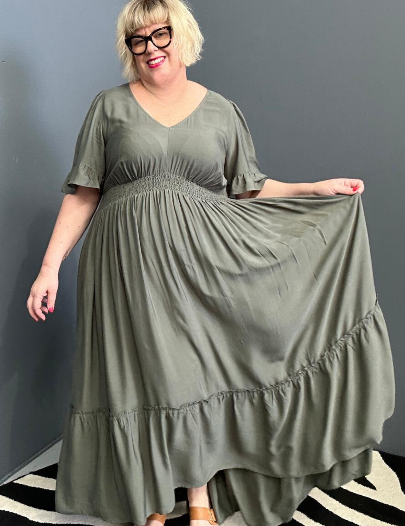 Plus-size olive maxi dress with a soft, flowing silhouette.