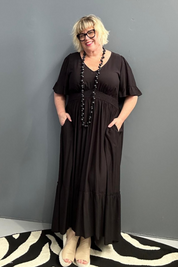 Plus-size black maxi dress with a soft, flowing silhouette.
