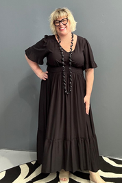 Plus-size black maxi dress with a soft, flowing silhouette.