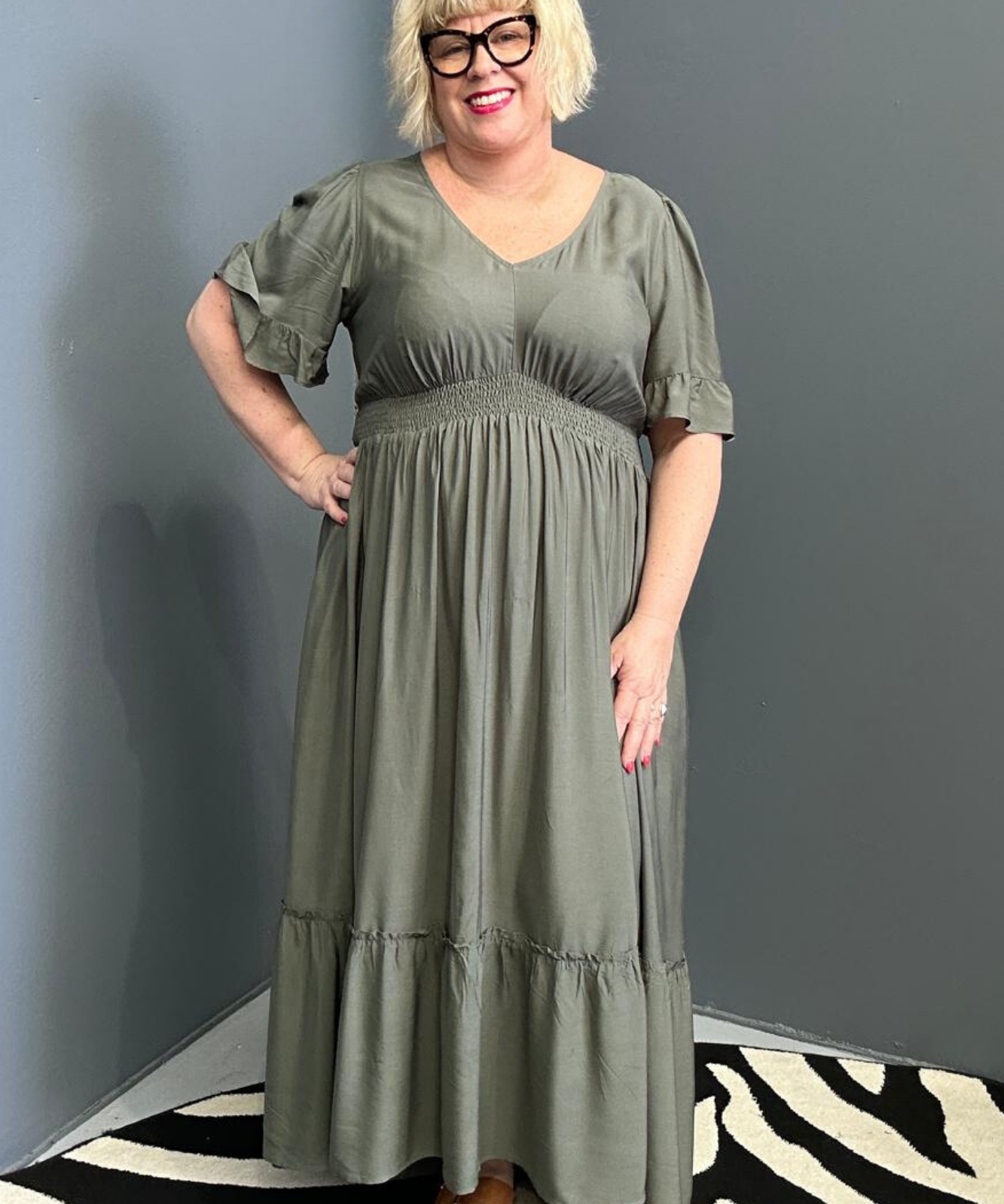 Plus-size olive maxi dress with a soft, flowing silhouette.