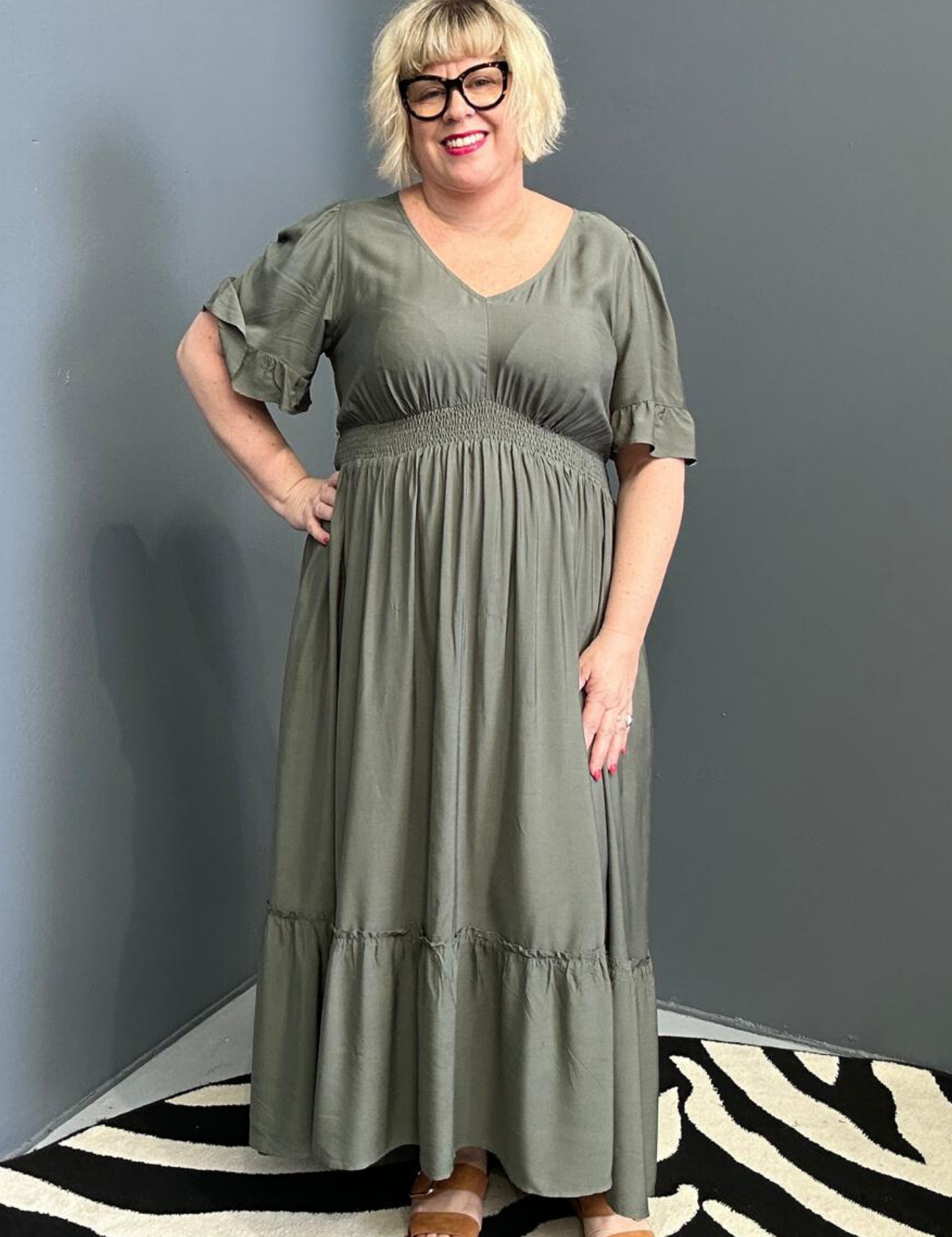 Plus-size olive maxi dress with a soft, flowing silhouette.