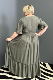 Plus-size olive maxi dress with a soft, flowing silhouette.