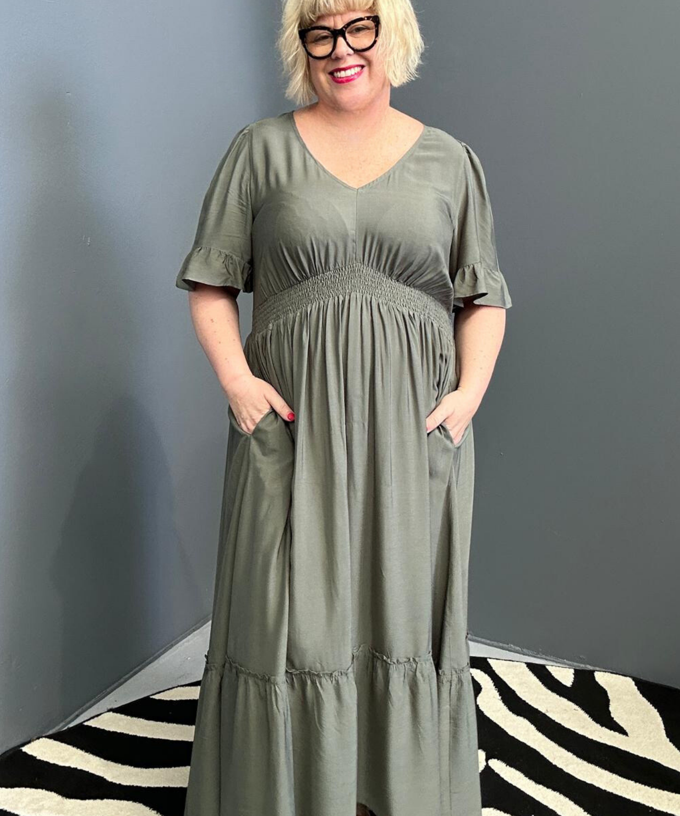 Plus-size olive maxi dress with a soft, flowing silhouette.