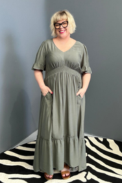 Plus-size olive maxi dress with a soft, flowing silhouette.