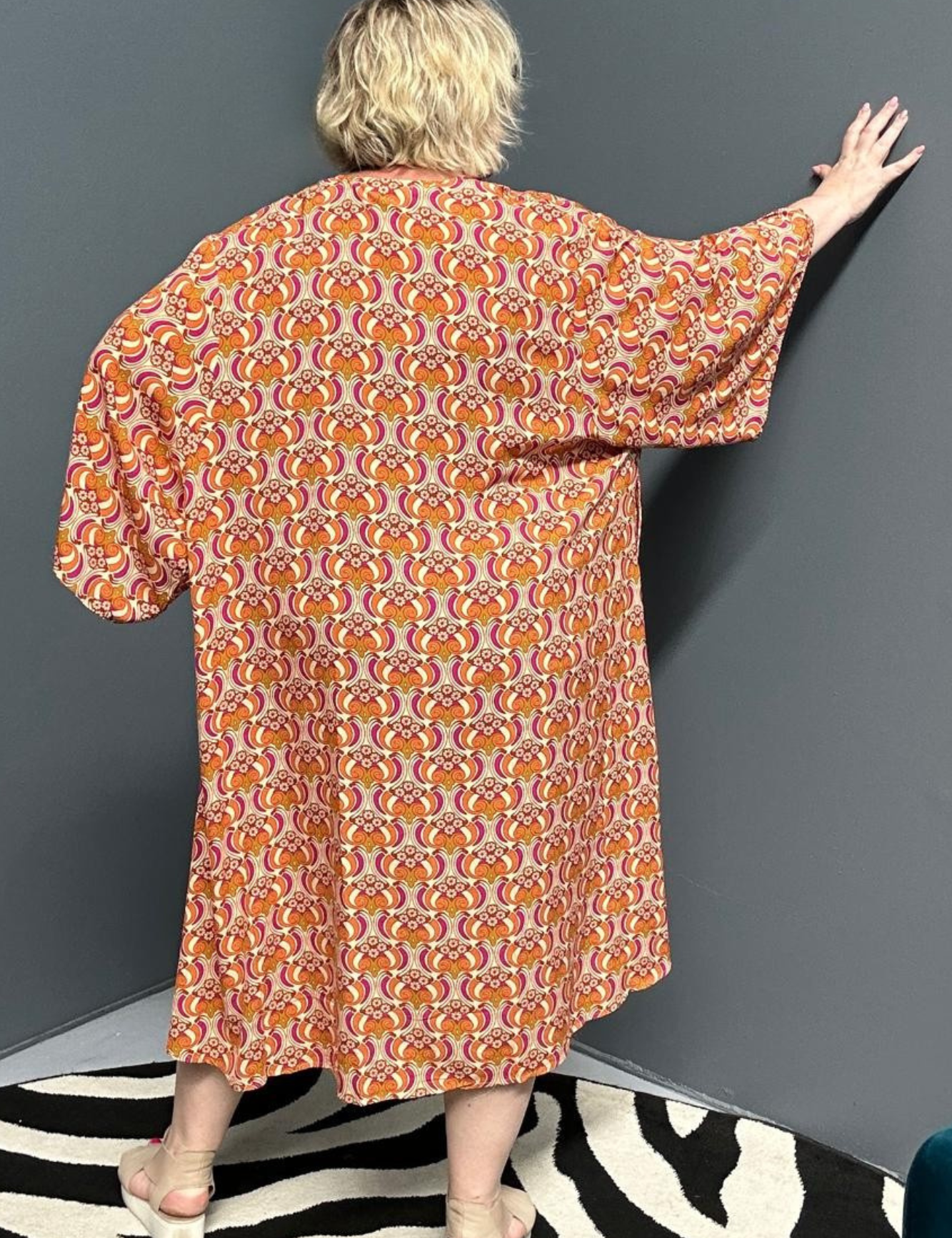 Flowy kimono duster with a vibrant Orange Swirl print.