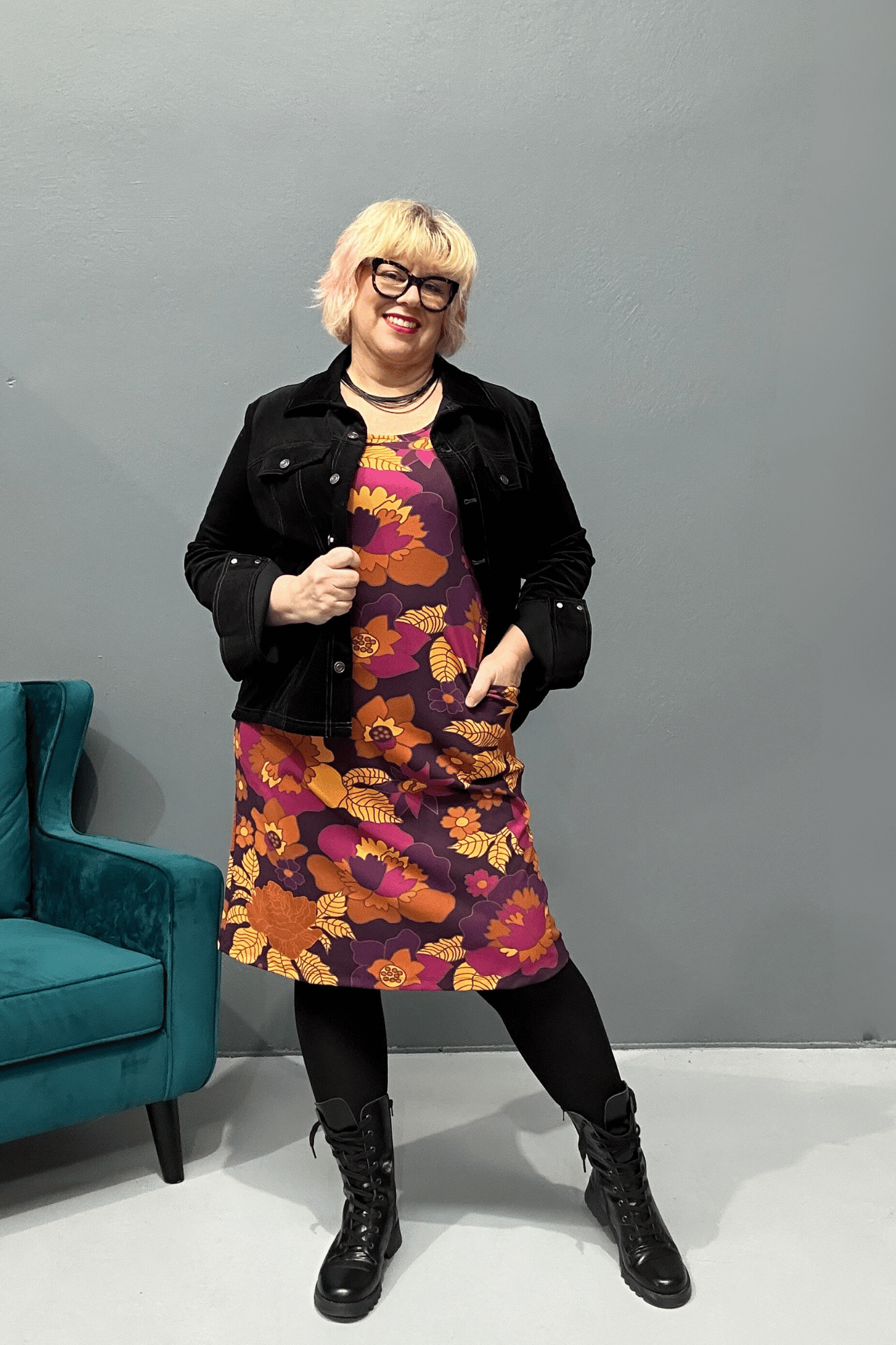 Plus size 'AUDREY' stretch crepe dress with a classic '60s fit, featuring a pink, purple, and caramel retro floral pattern for a stylish look that transitions from work to evening wear.