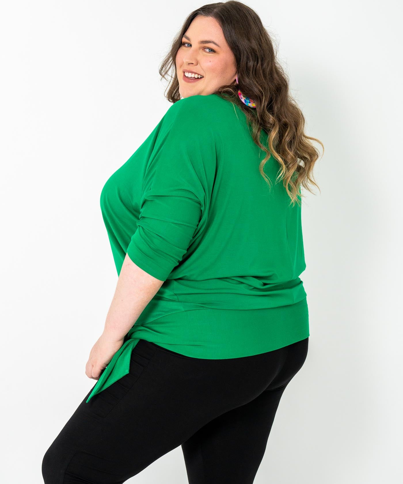 Plus-size Bat Wing Top in Green Tambourine with a stylish batwing cut and adjustable side ties for a customized fit.