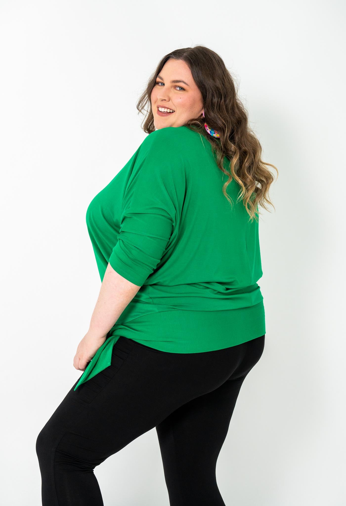 Plus-size Bat Wing Top in Green Tambourine with a stylish batwing cut and adjustable side ties for a customized fit.