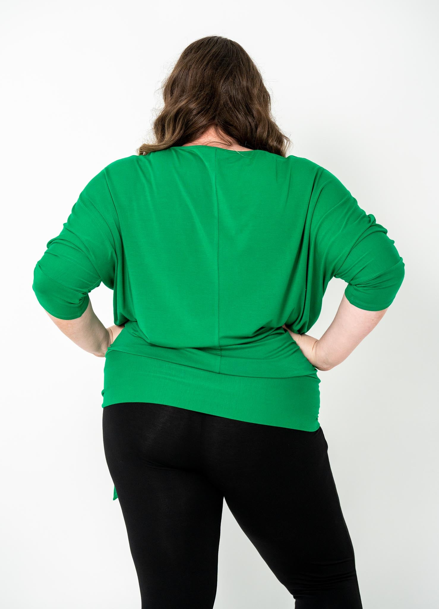 Plus-size Bat Wing Top in Green Tambourine with a stylish batwing cut and adjustable side ties for a customized fit.