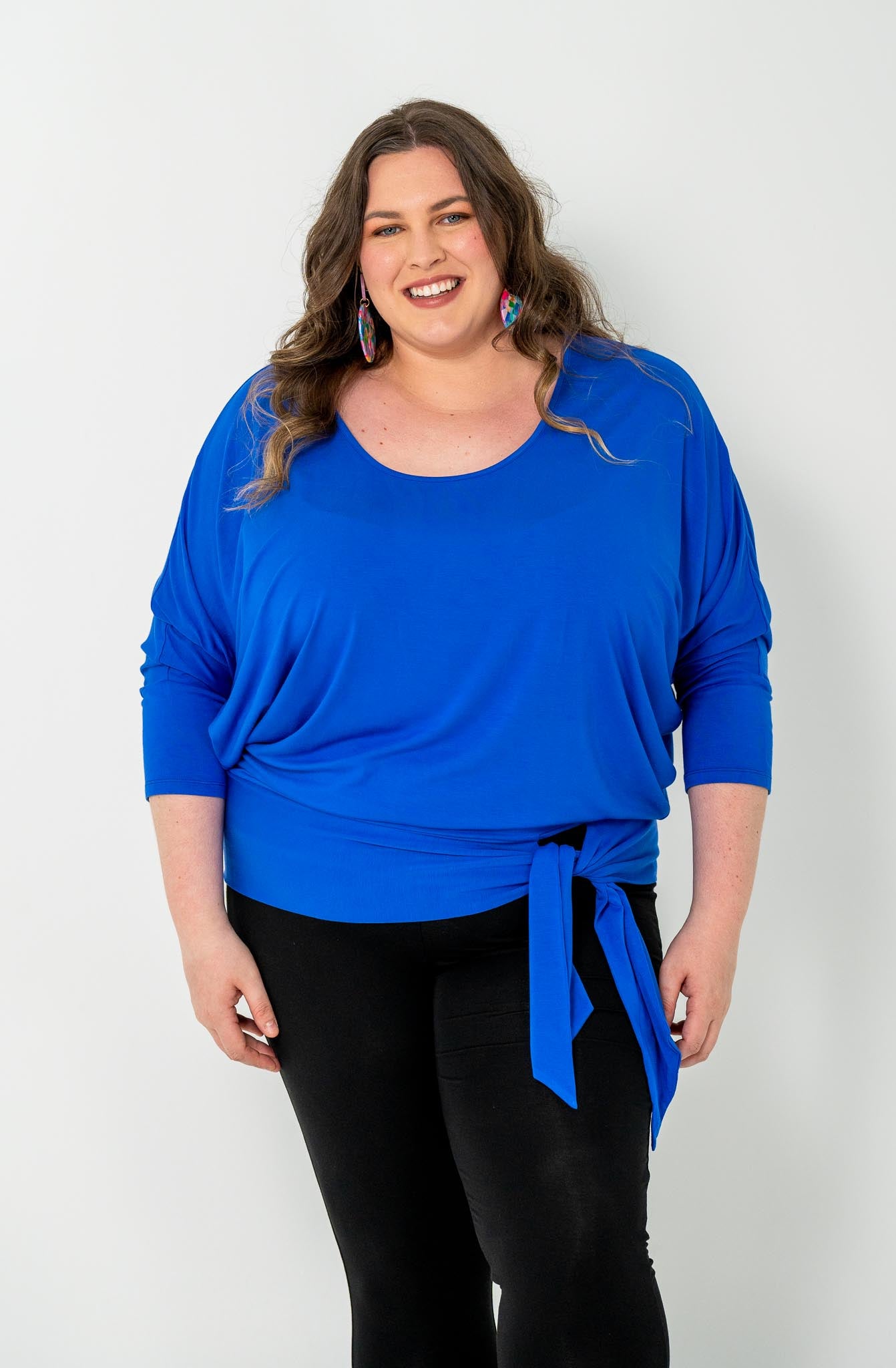 'GEORGIA' plus-size top with a sleek color, batwing cut, and adjustable side ties for a customizable fit.