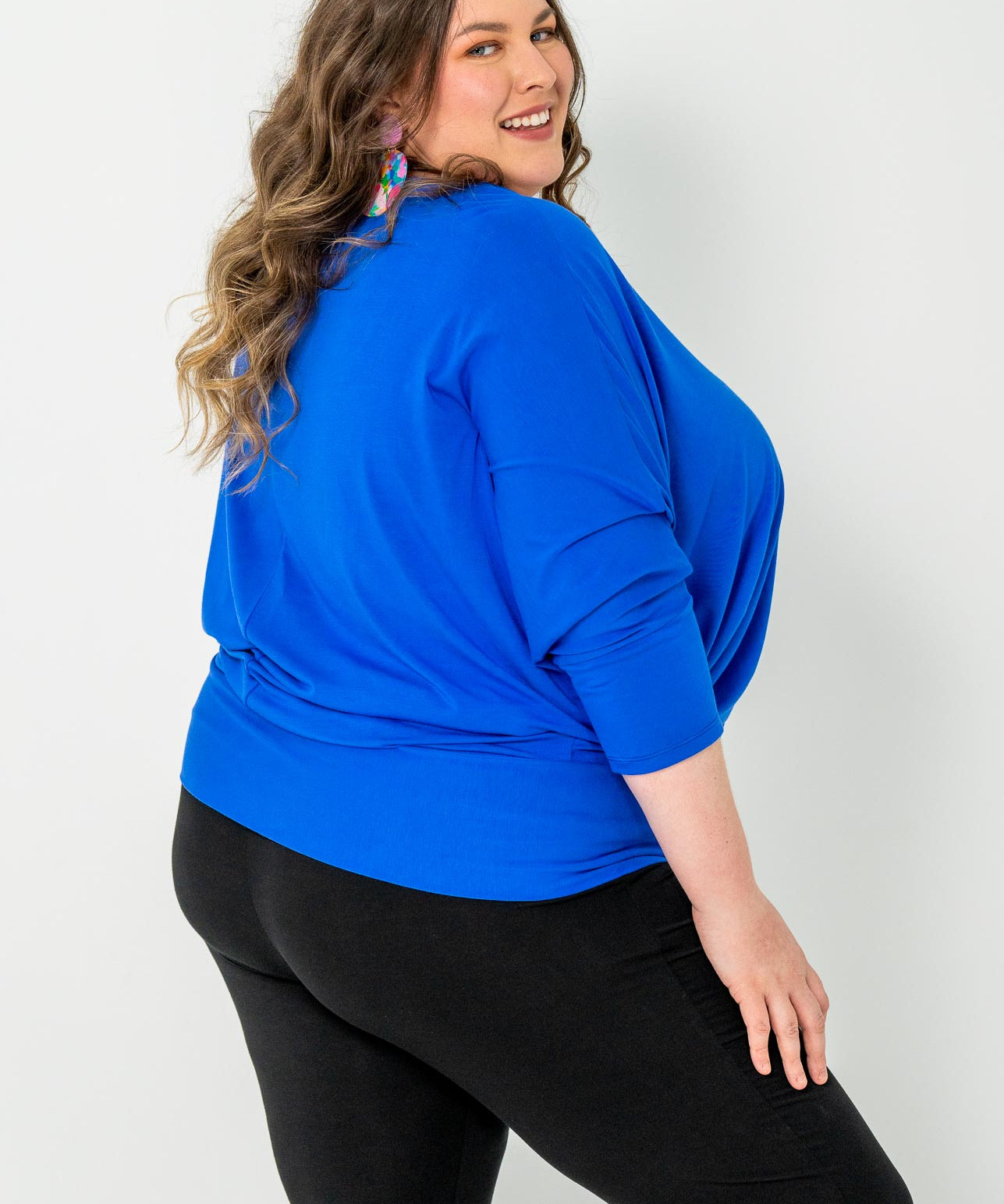 'GEORGIA' plus-size top with a sleek color, batwing cut, and adjustable side ties for a customizable fit.