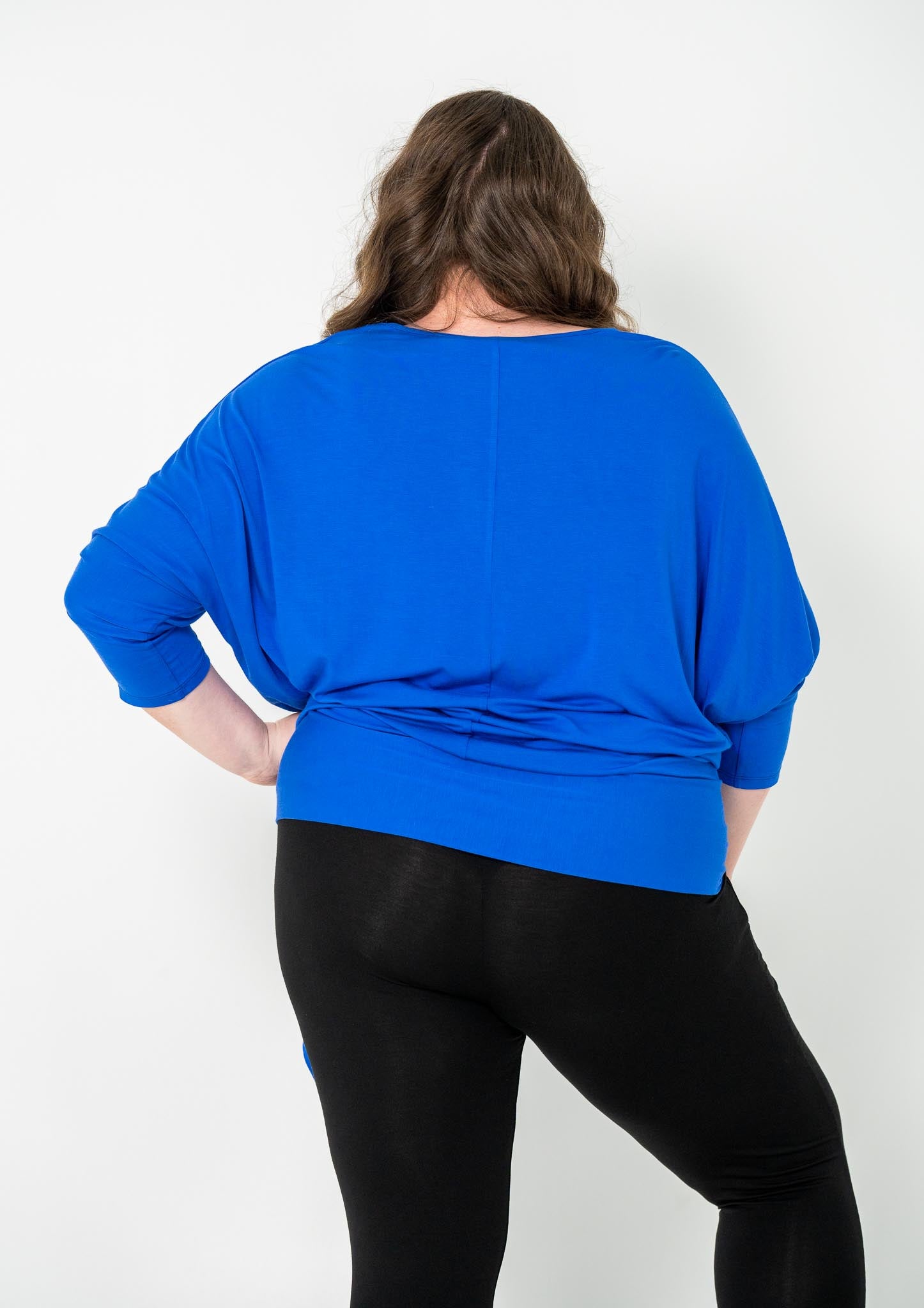 'GEORGIA' plus-size top with a sleek color, batwing cut, and adjustable side ties for a customizable fit.