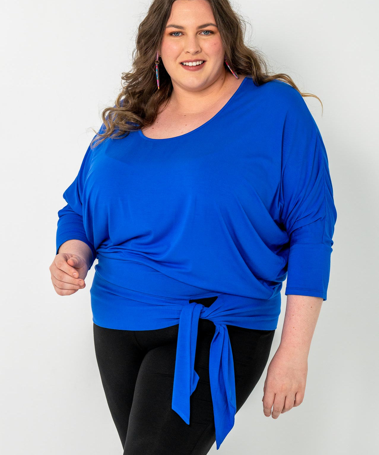 'GEORGIA' plus-size top with a sleek color, batwing cut, and adjustable side ties for a customizable fit.