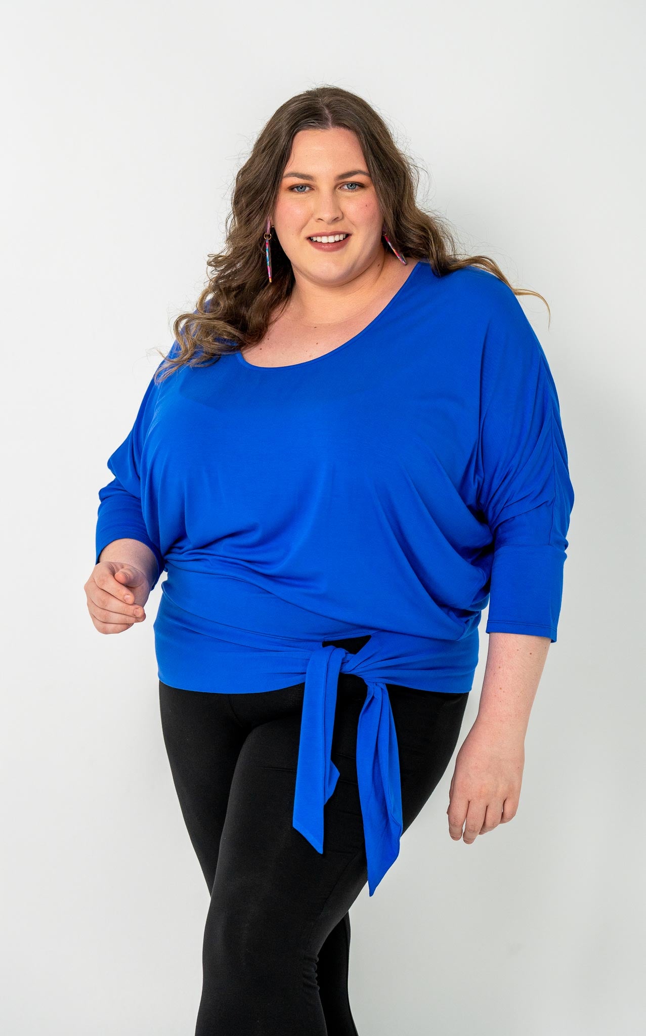 'GEORGIA' plus-size top with a sleek color, batwing cut, and adjustable side ties for a customizable fit.