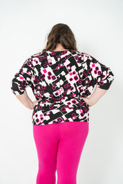 Plus-size 'GEORGIA' Bat Wing Top in pink with a modern geo square print and stylish bat wing design.