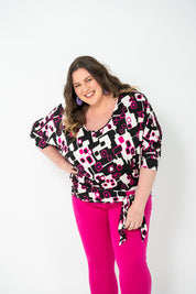 Plus-size 'GEORGIA' Bat Wing Top in pink with a modern geo square print and stylish bat wing design.