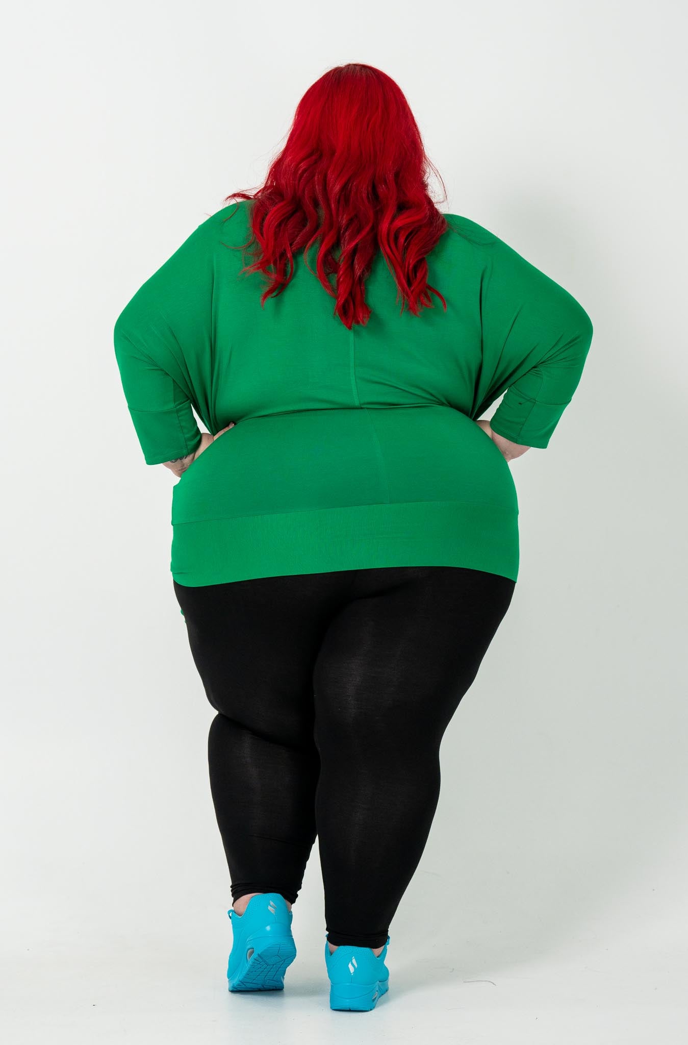 Plus-size Bat Wing Top in Green Tambourine with a stylish batwing cut and adjustable side ties for a customized fit.