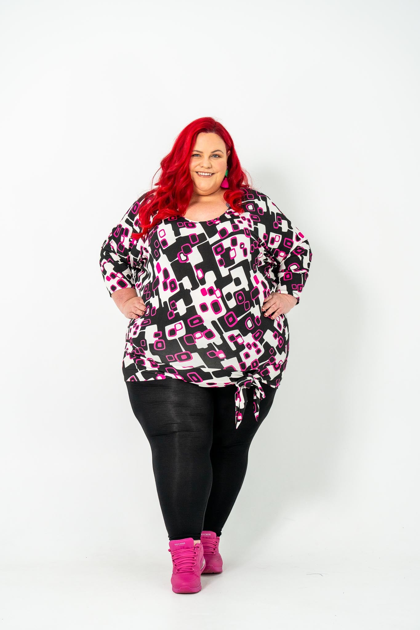 Plus-size 'GEORGIA' Bat Wing Top in pink with a modern geo square print and stylish bat wing design.