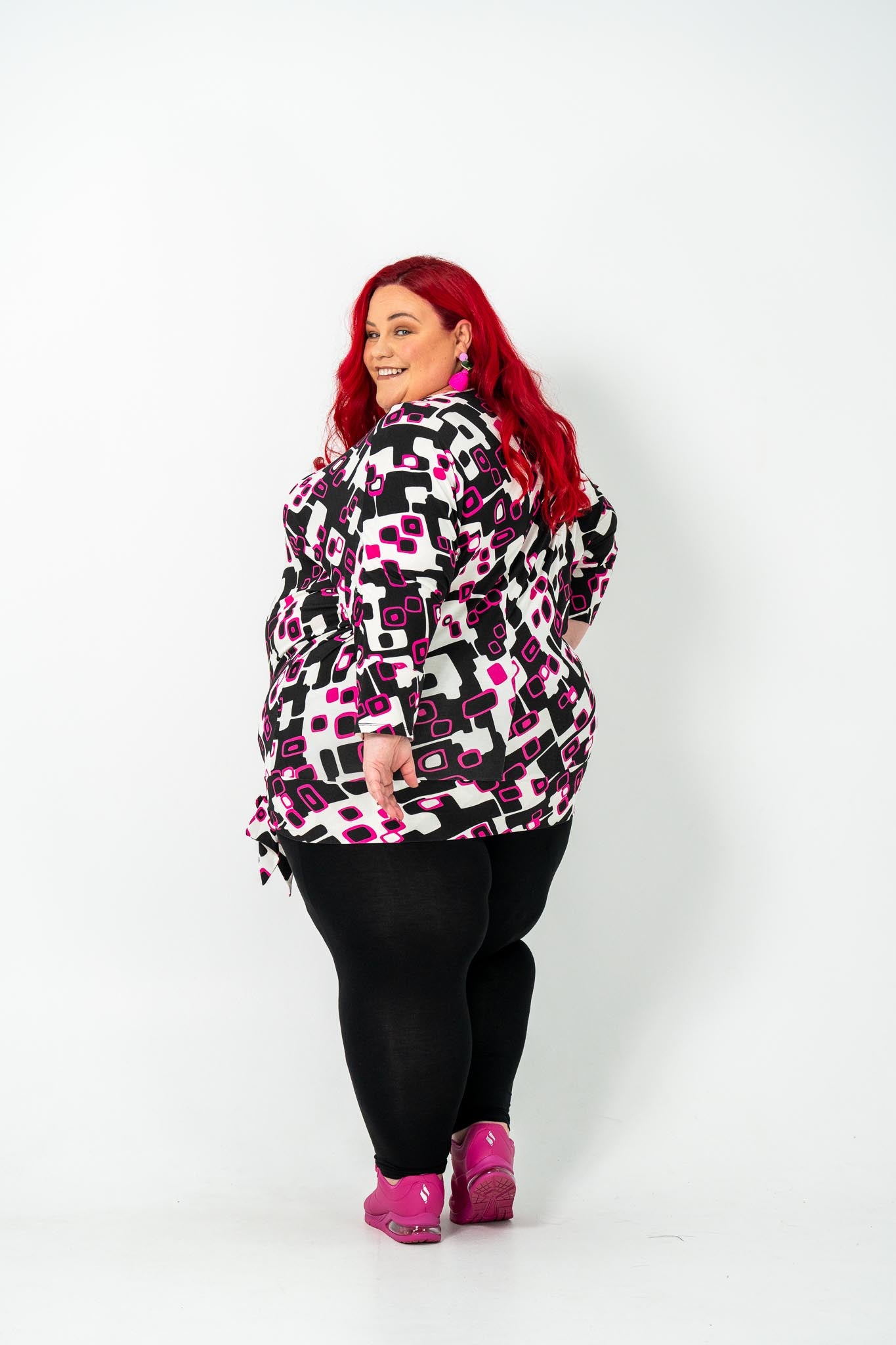 Plus-size 'GEORGIA' Bat Wing Top in pink with a modern geo square print and stylish bat wing design.