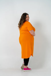 Plus size 'ALANA' T-Shirt dress in vibrant orange with a classic silhouette and pockets, perfect for layering with jackets or kimonos.