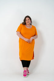 Plus size 'ALANA' T-Shirt dress in vibrant orange with a classic silhouette and pockets, perfect for layering with jackets or kimonos.