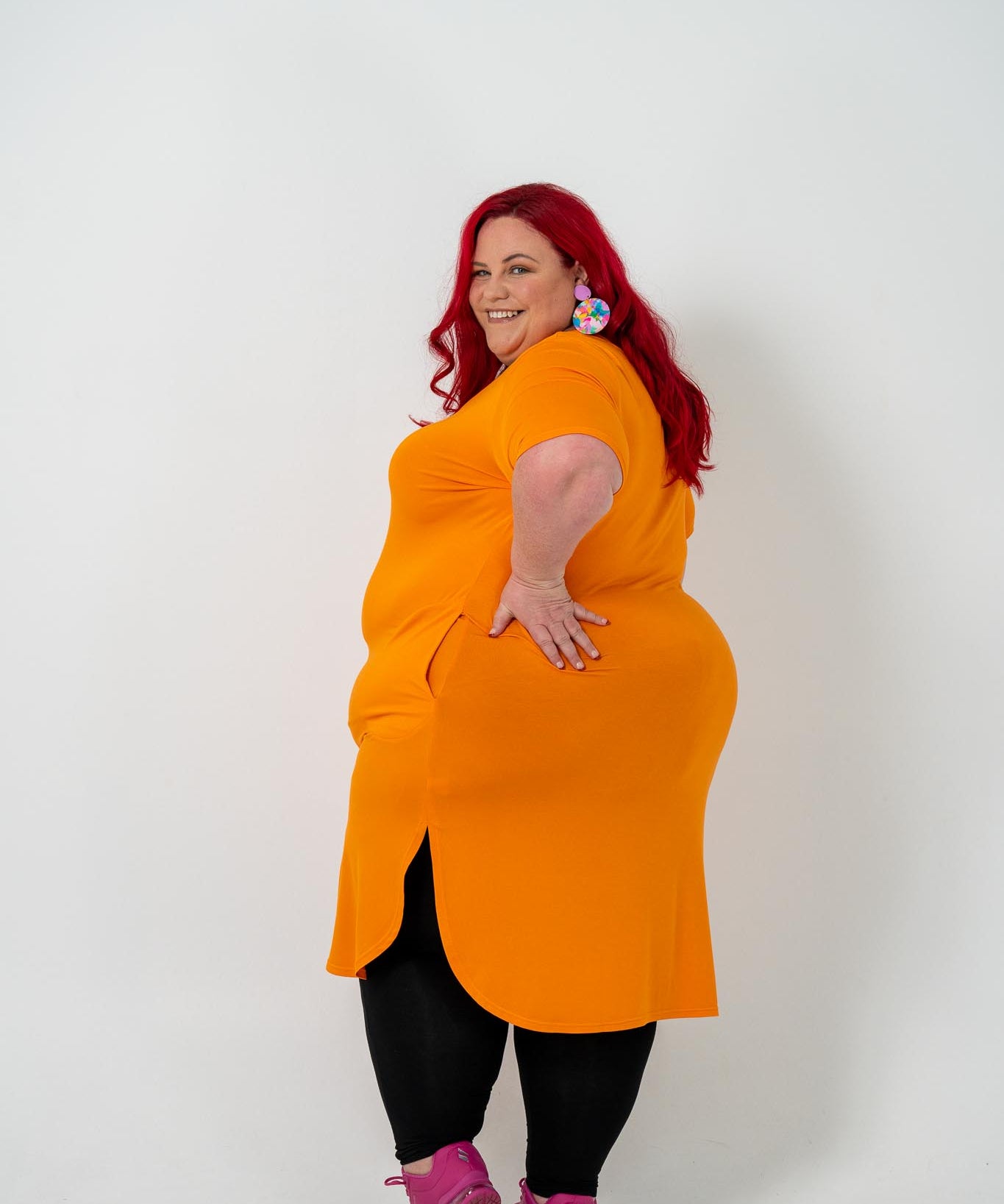 Plus size 'ALANA' T-Shirt dress in vibrant orange with a classic silhouette and pockets, perfect for layering with jackets or kimonos.