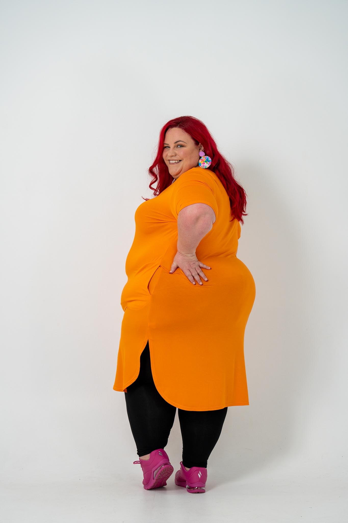 Plus size 'ALANA' T-Shirt dress in vibrant orange with a classic silhouette and pockets, perfect for layering with jackets or kimonos.