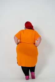 Plus size 'ALANA' T-Shirt dress in vibrant orange with a classic silhouette and pockets, perfect for layering with jackets or kimonos.