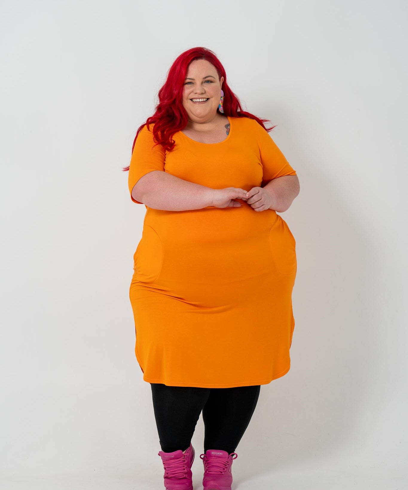 Plus size 'ALANA' T-Shirt dress in vibrant orange with a classic silhouette and pockets, perfect for layering with jackets or kimonos.