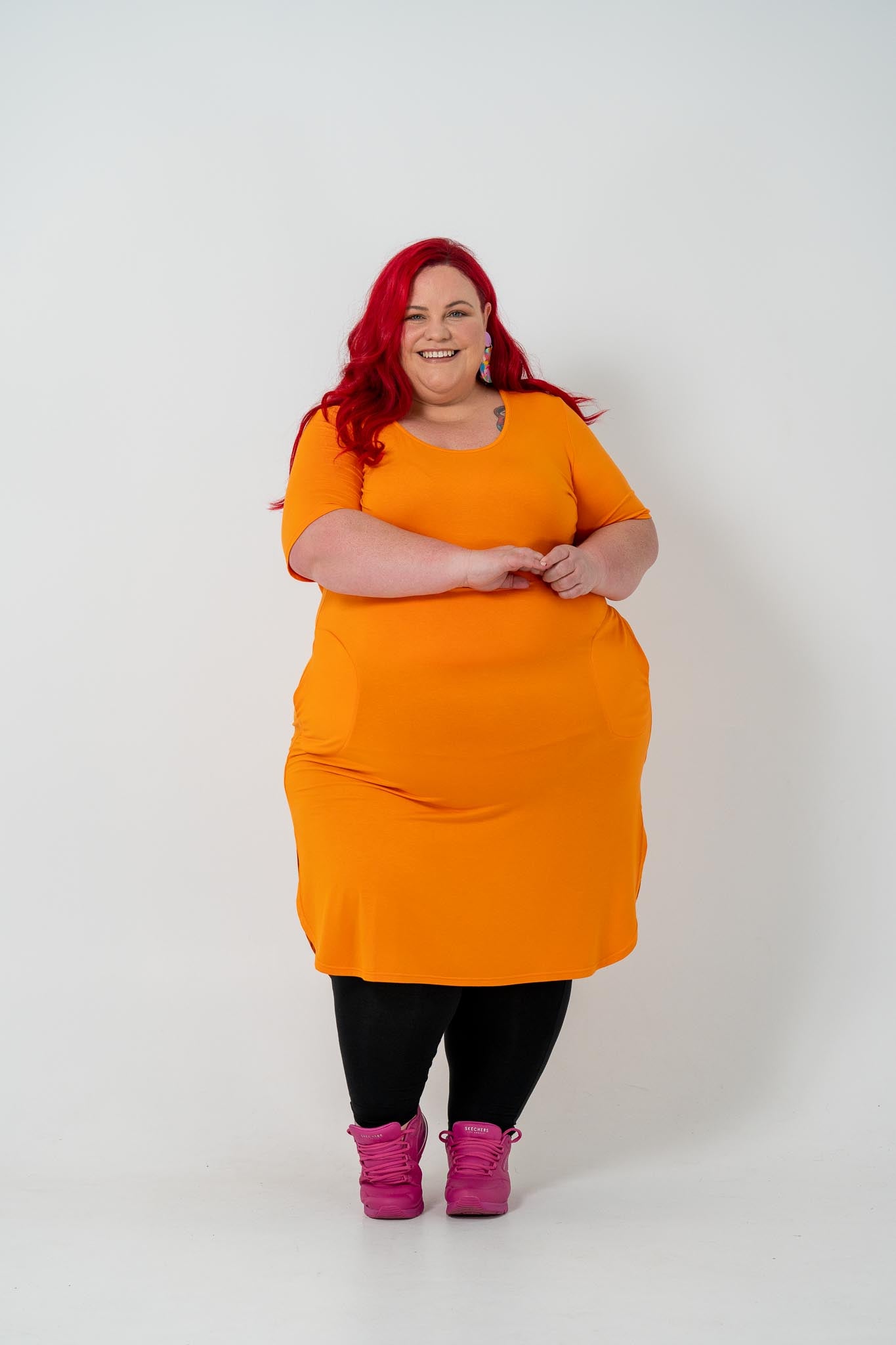 Plus size 'ALANA' T-Shirt dress in vibrant orange with a classic silhouette and pockets, perfect for layering with jackets or kimonos.