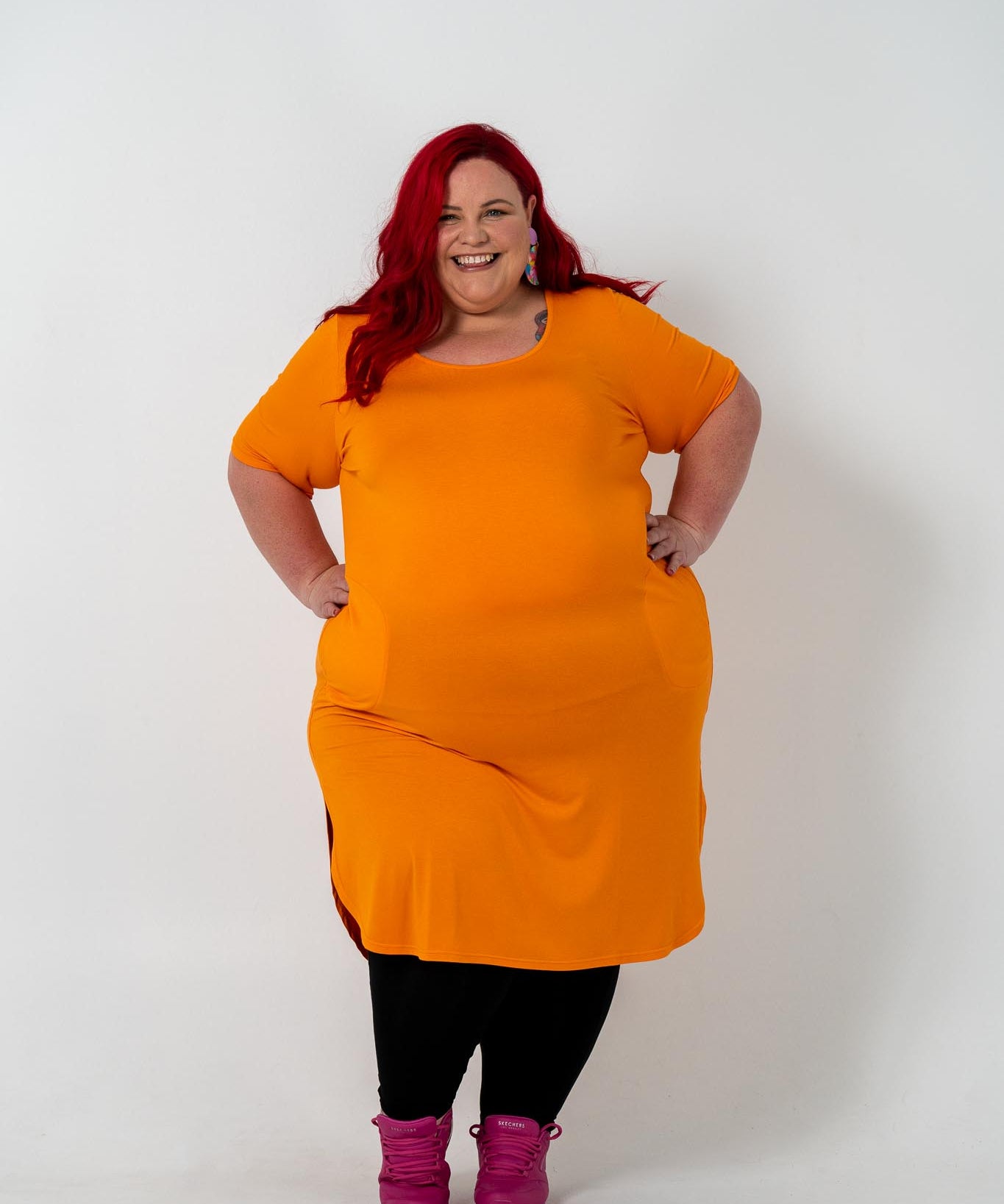 Plus size 'ALANA' T-Shirt dress in vibrant orange with a classic silhouette and pockets, perfect for layering with jackets or kimonos.