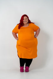 Plus size 'ALANA' T-Shirt dress in vibrant orange with a classic silhouette and pockets, perfect for layering with jackets or kimonos.