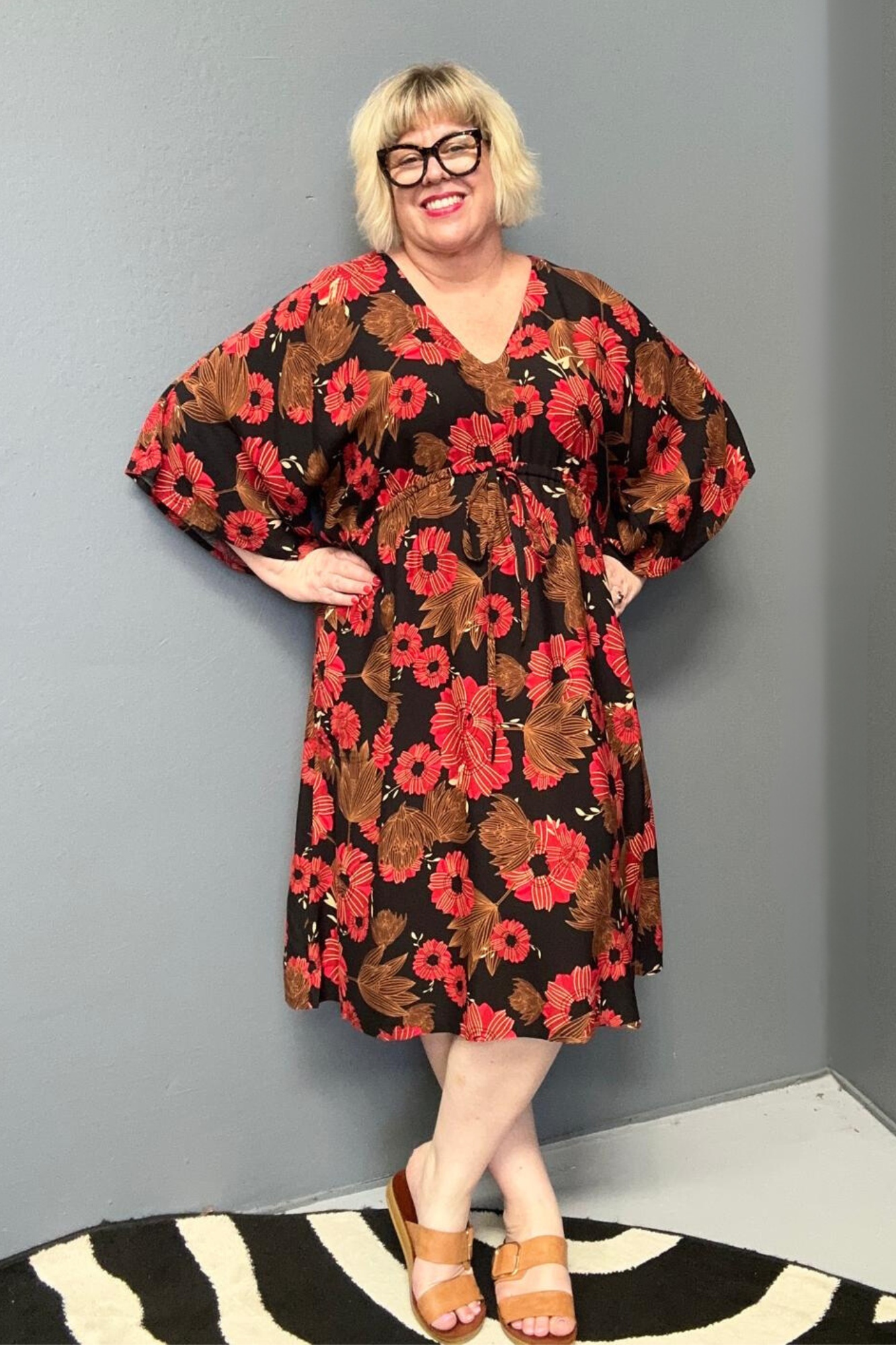 Plus-size black and red floral dress with a flattering drawstring waist.