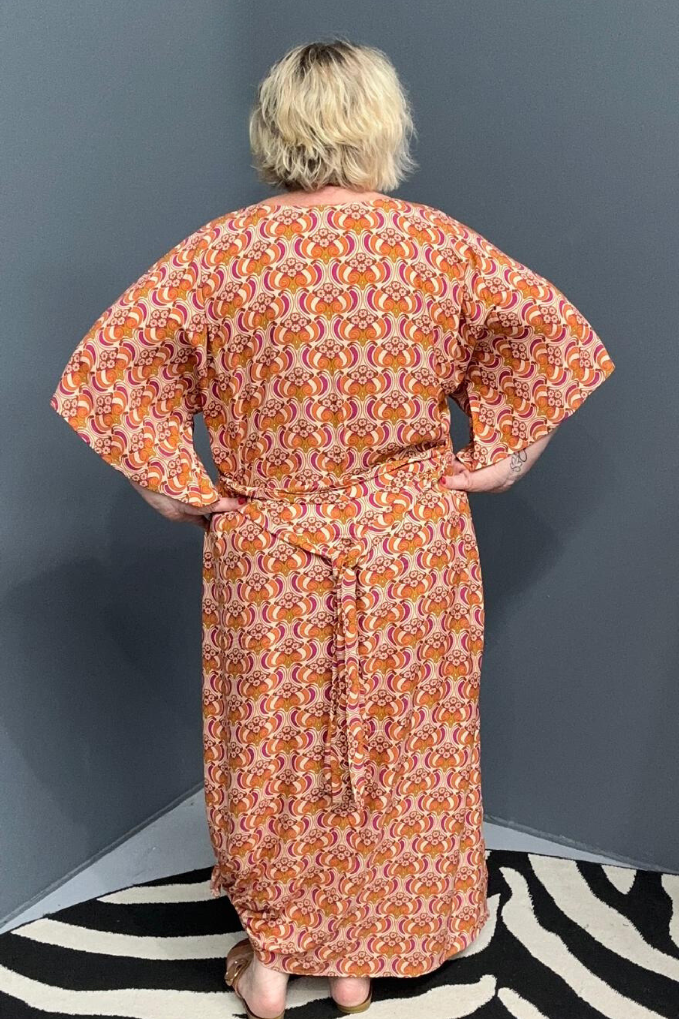 Plus-size orange swirl dress with a flattering fit and effortless flow.