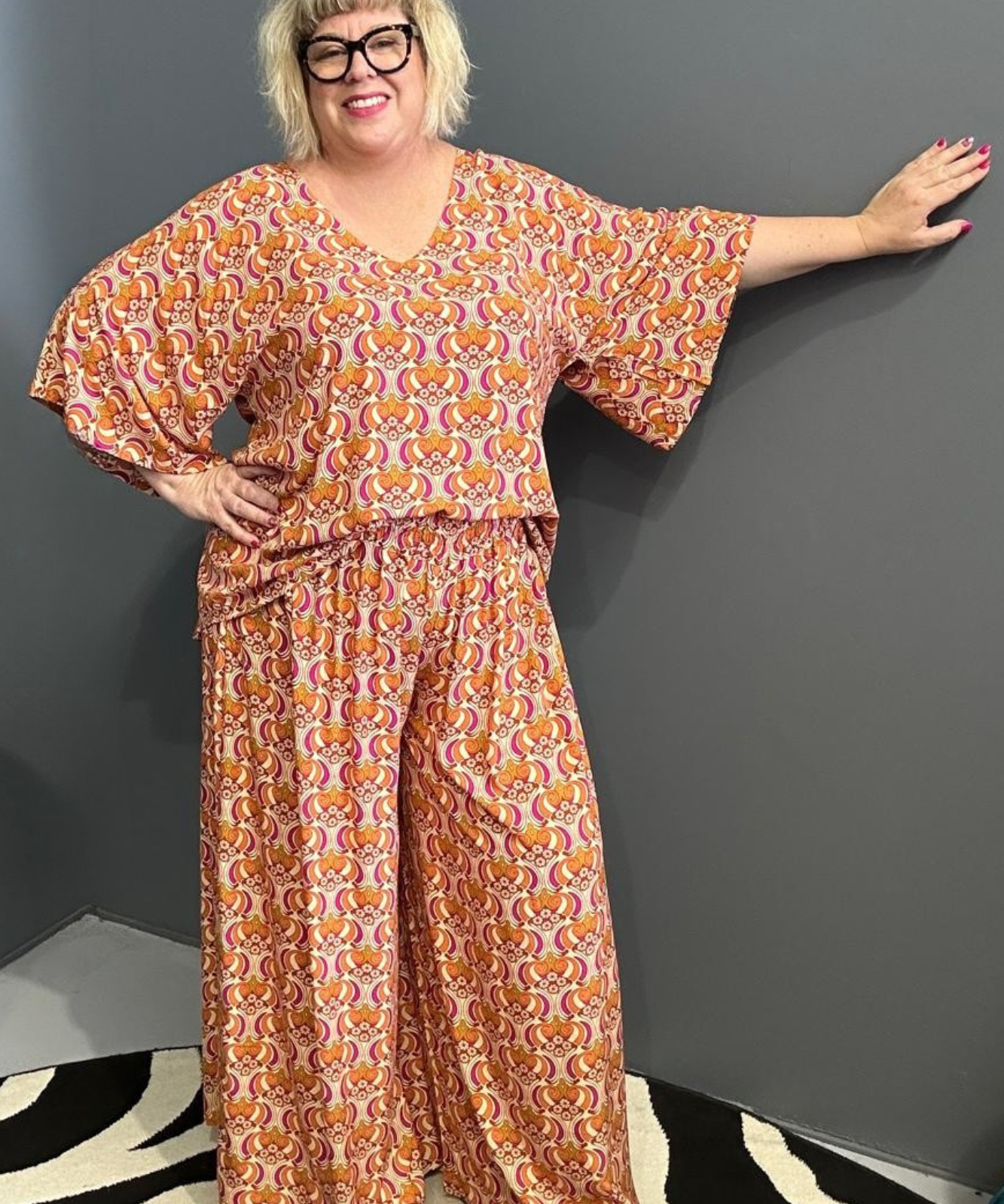 Plus-size orange swirl top with a stylish, flowy fit.