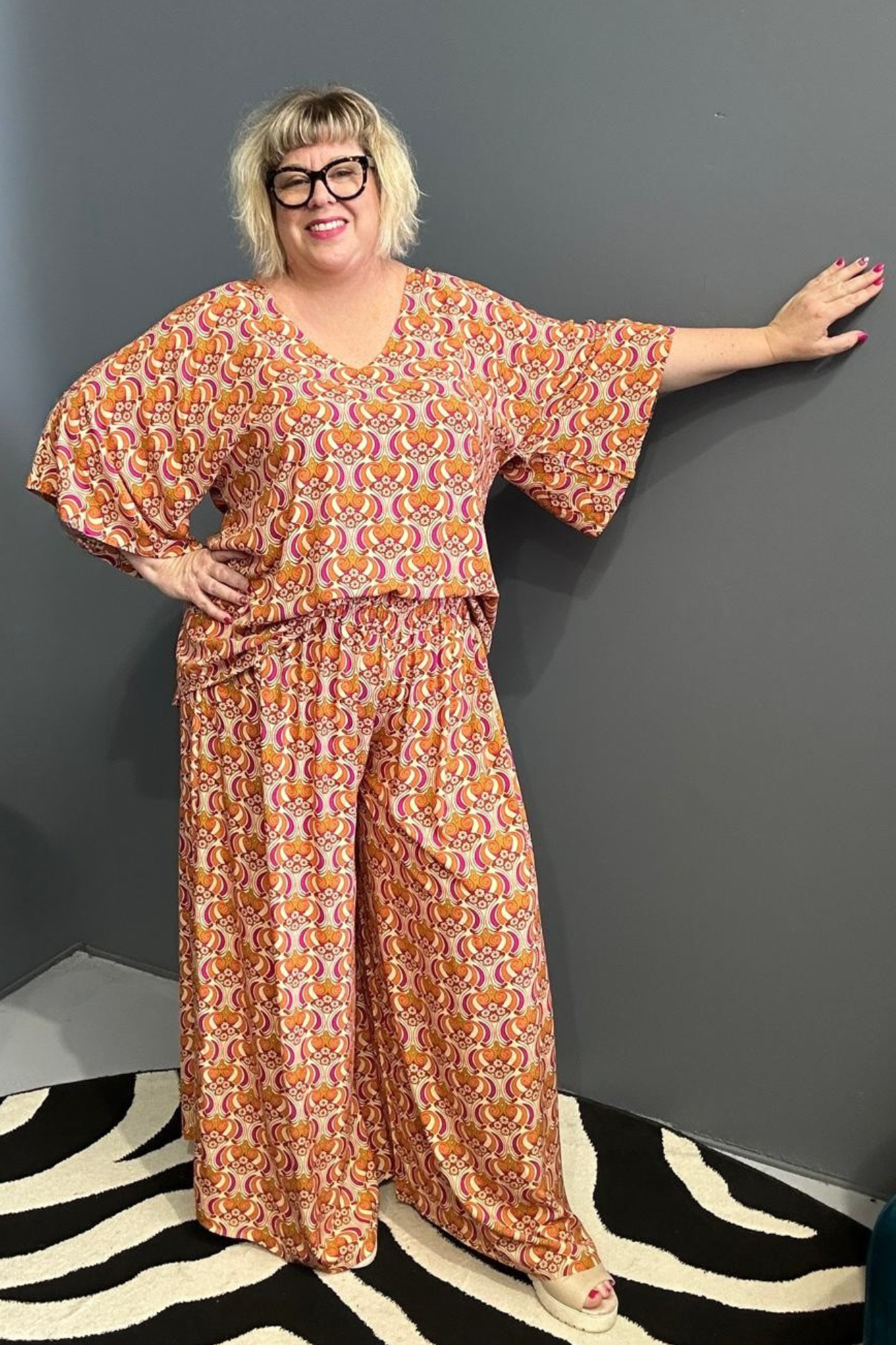 Plus-size orange swirl top with a stylish, flowy fit.