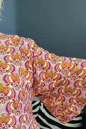 Plus-size orange swirl top with a stylish, flowy fit.