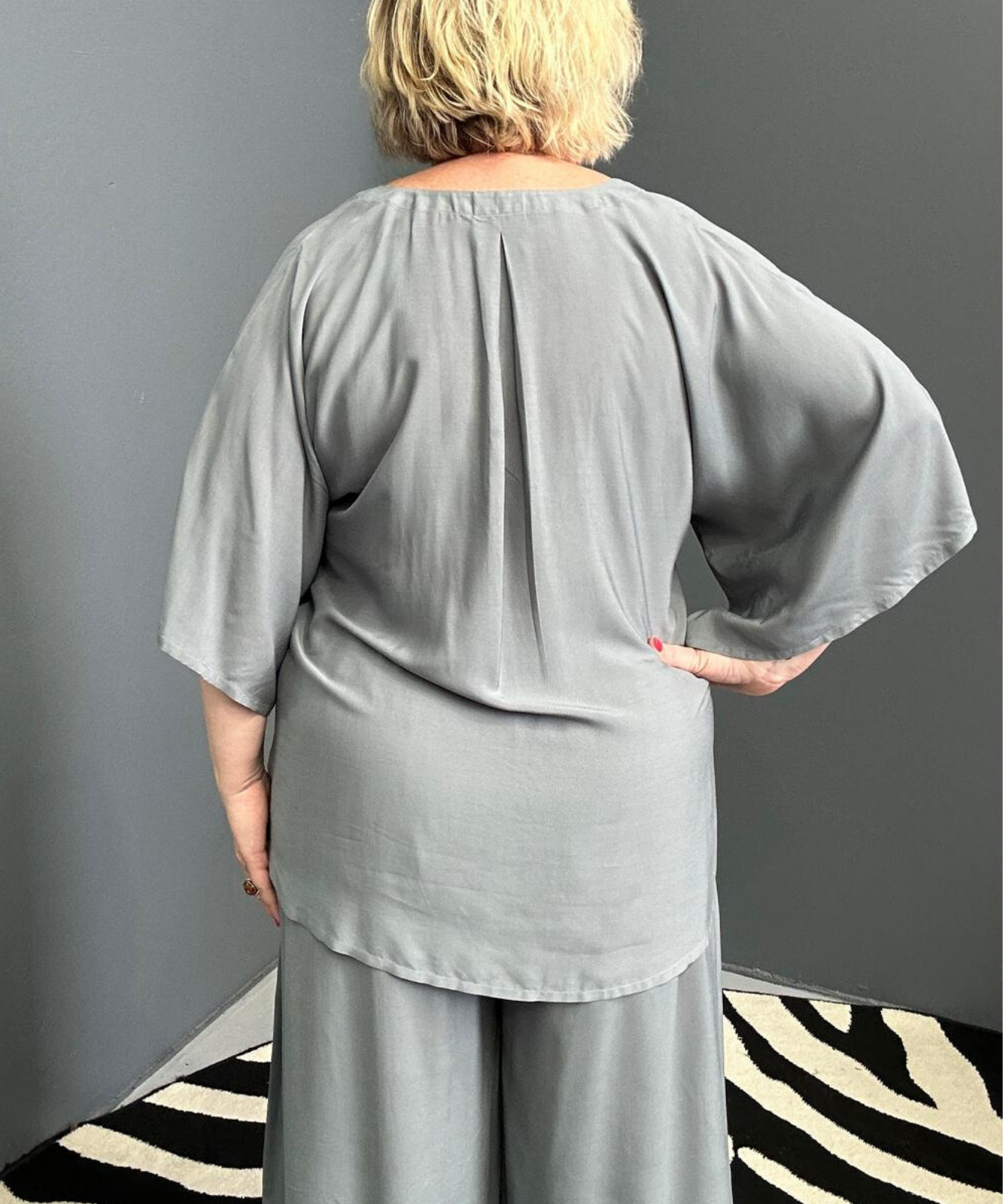 Plus-size sage green top with a stylish, flowy fit.