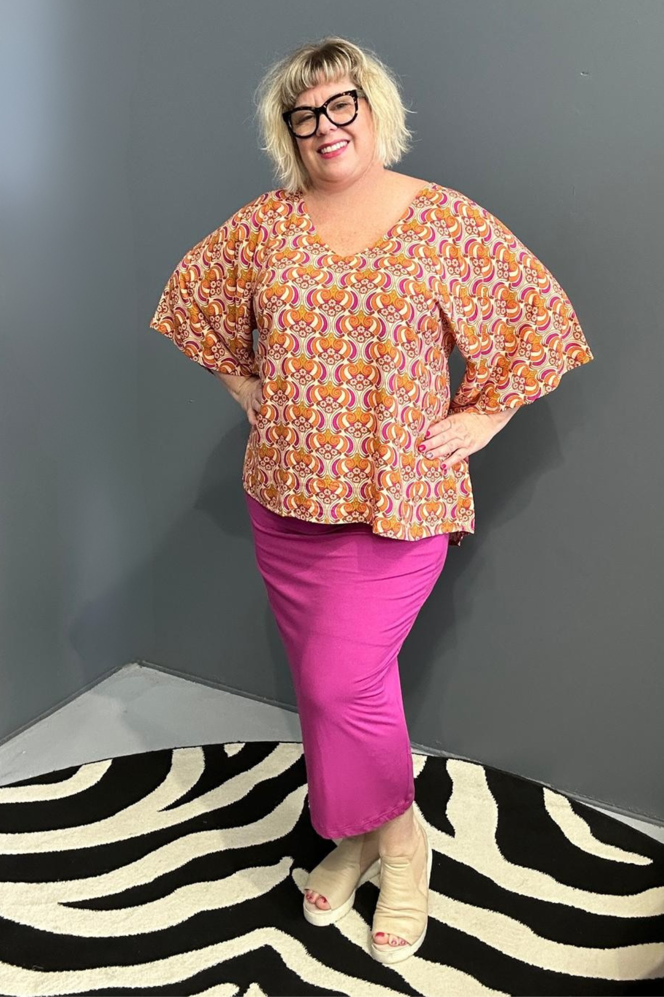 Plus-size orange swirl top with a stylish, flowy fit.