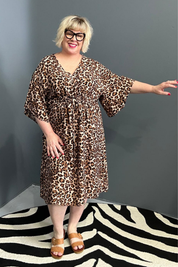 Plus-size leopard print dress with a flattering drawstring waist.