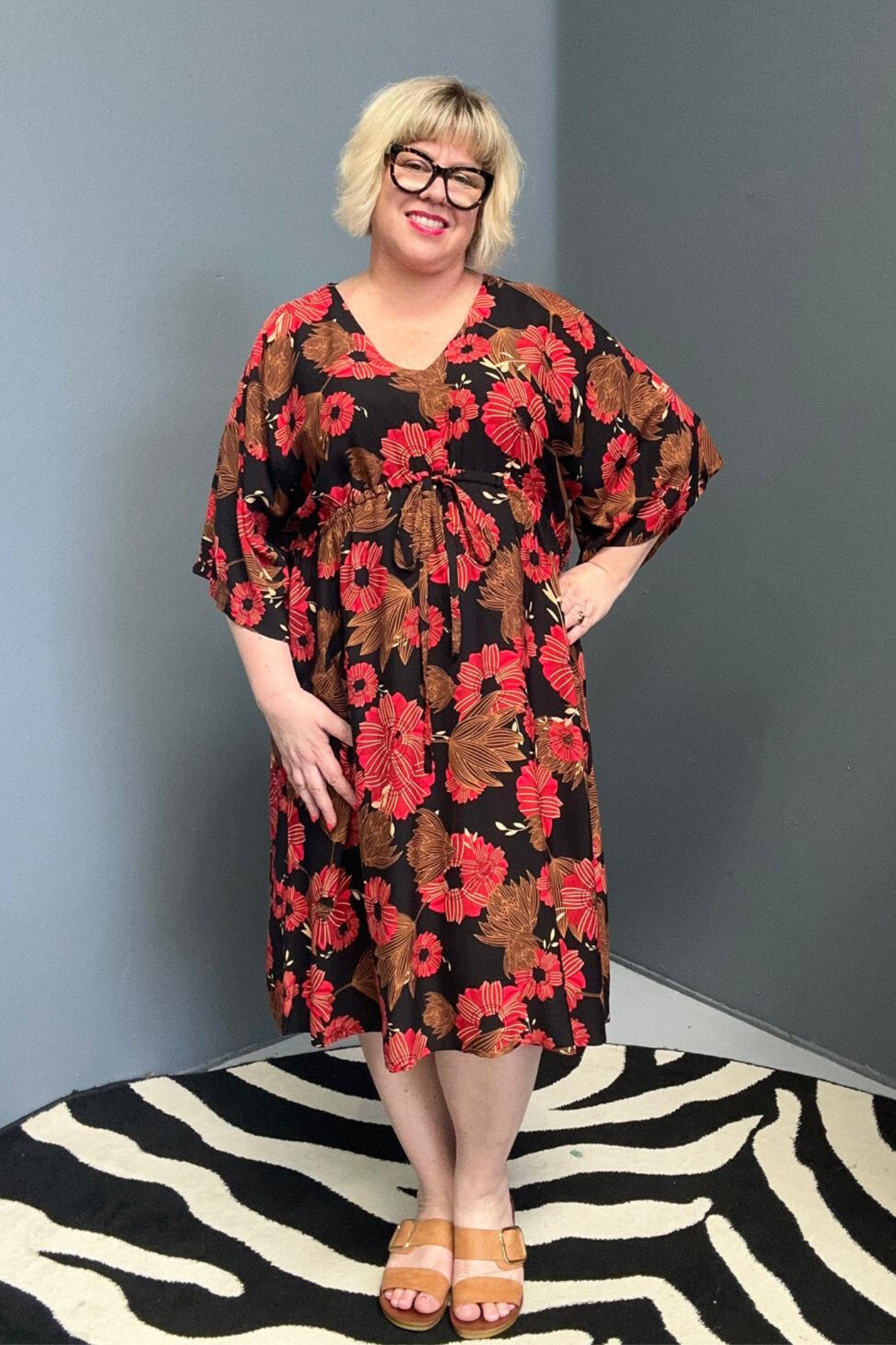 Plus-size black and red floral dress with a flattering drawstring waist.