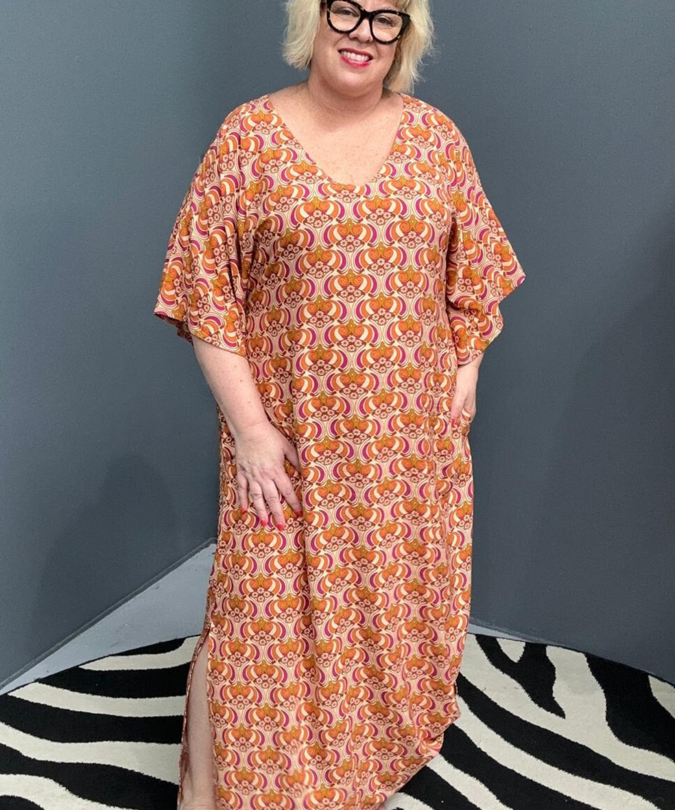 Plus-size orange swirl dress with a flattering fit and effortless flow.
