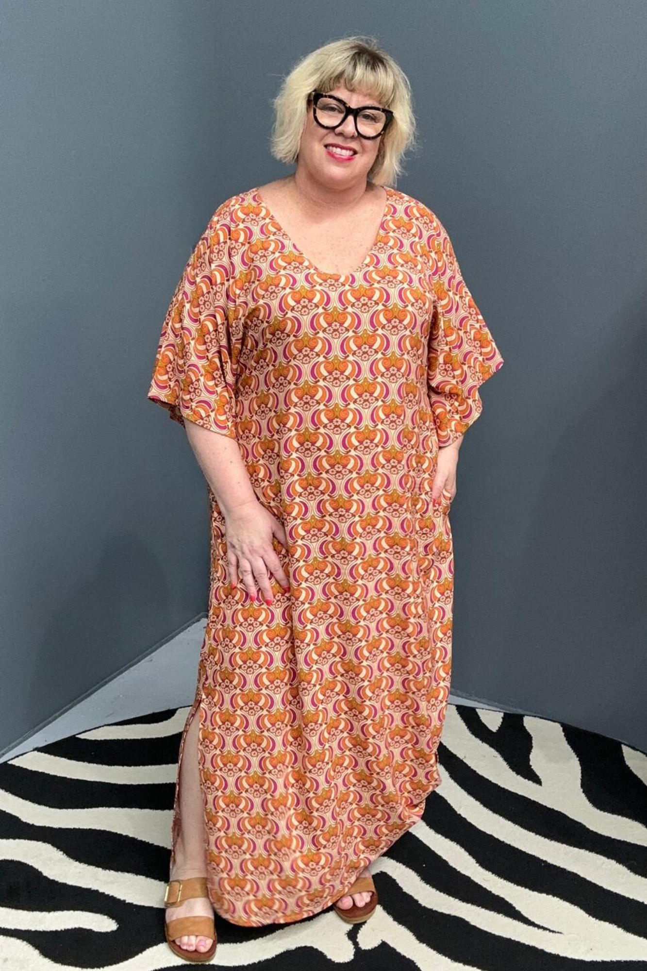 Plus-size orange swirl dress with a flattering fit and effortless flow.