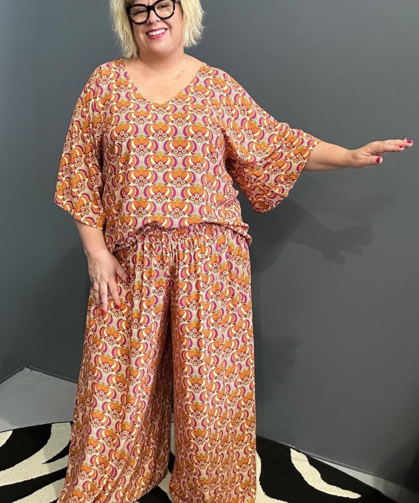 Plus-size orange swirl top with a stylish, flowy fit.
